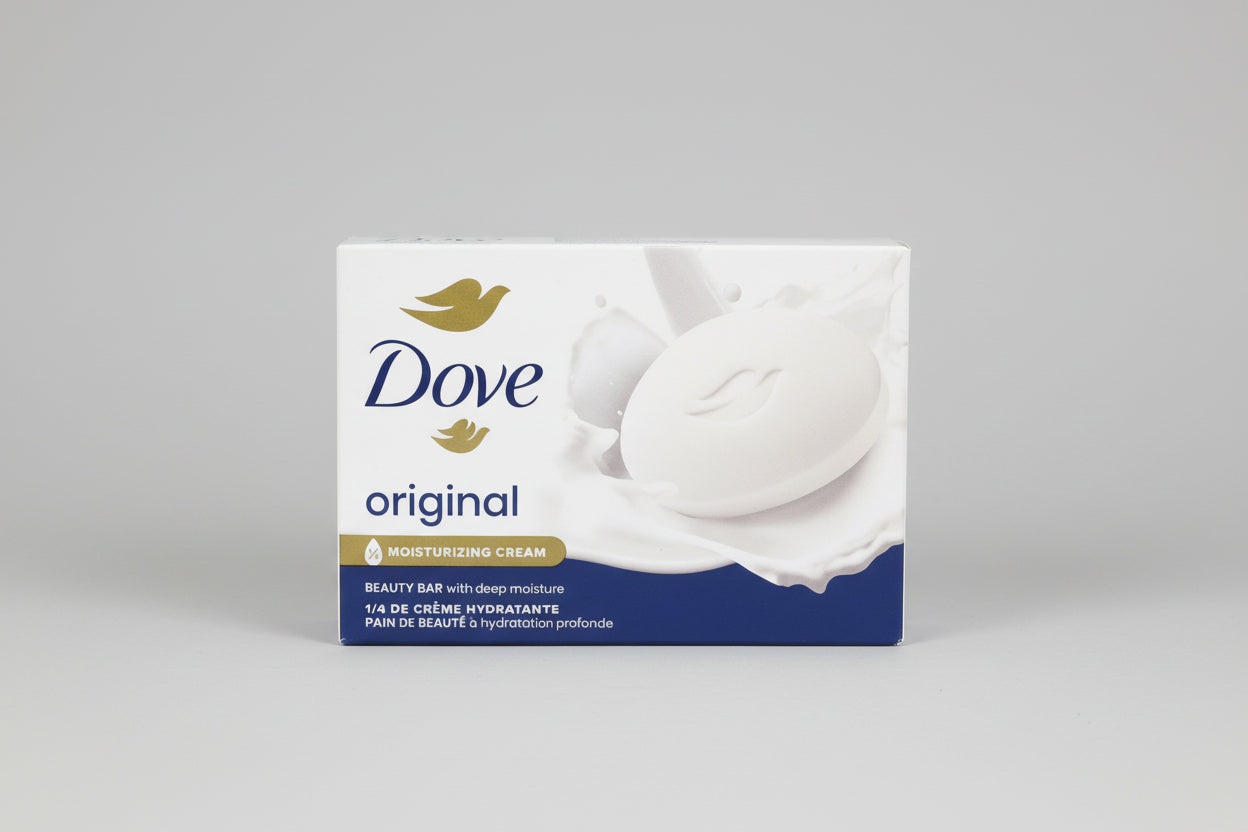 Dove soap bar packaging on a wooden surface with a blue background