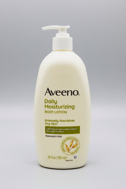 Aveeno Daily Moisturizing Body Lotion bottle on a wooden surface with a blurred background