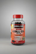 Kirkland Signature Krill Oil bottle on a wooden surface with a blurred background